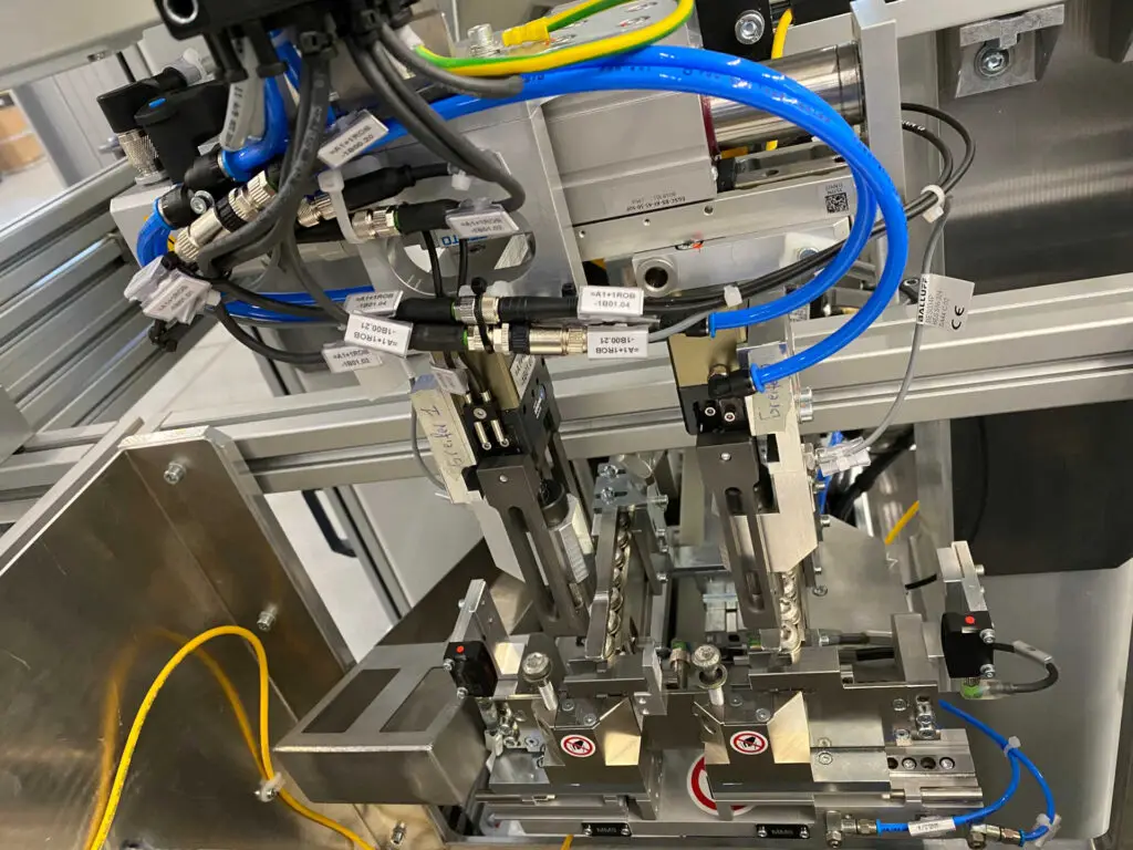 Innenansicht der Montageanlage von Ralf Lang Maschinenbau GmbH mit automatischer Schraubenzuführung und Scara-Roboter für Getriebe- und Mechatronikbaugruppen.